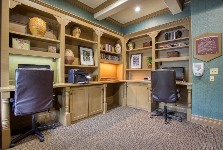 a home office with two desks and two chairs