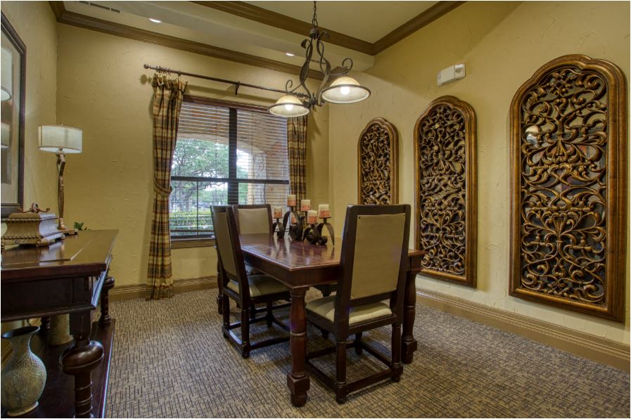 a dining room with a table and chairs
