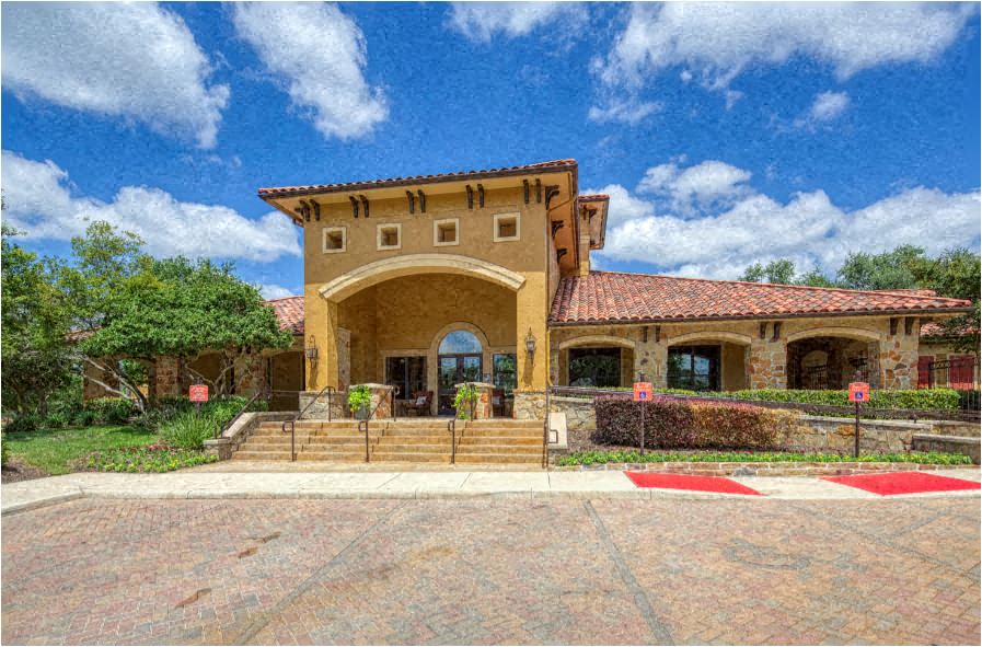 a large house with a courtyard and a blue sky