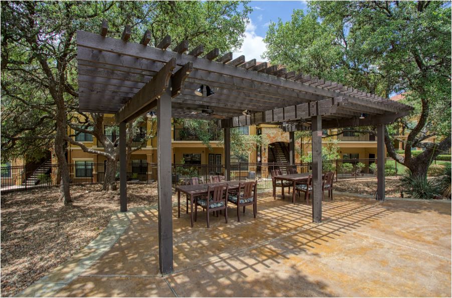 a patio with tables and a pergola