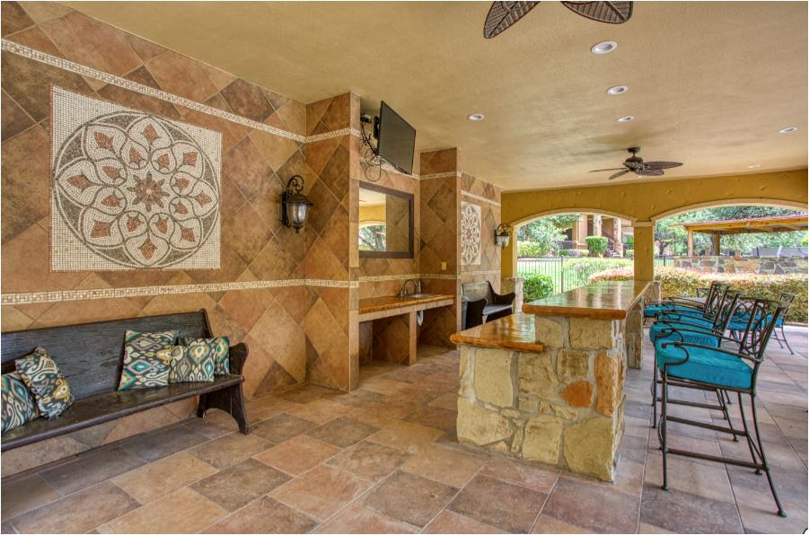 a kitchen with a bar and a seating area with chairs