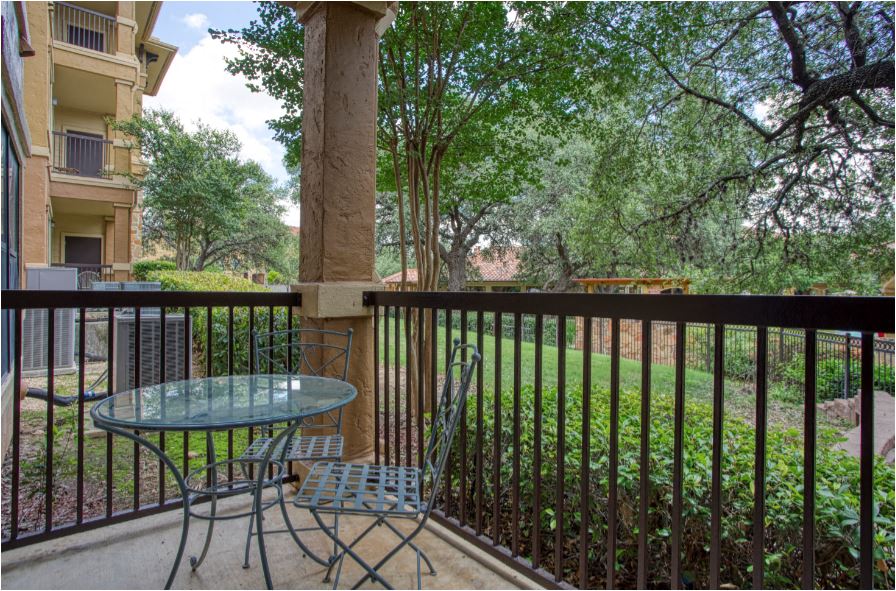 a patio with a table and chairs on a balcony