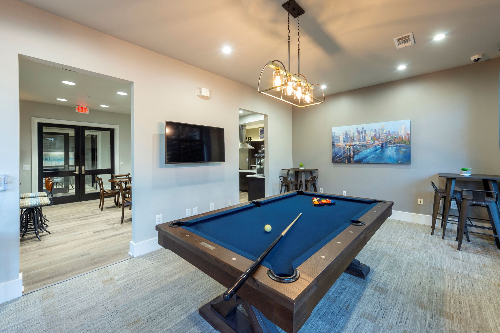a games room with a pool table and a tv