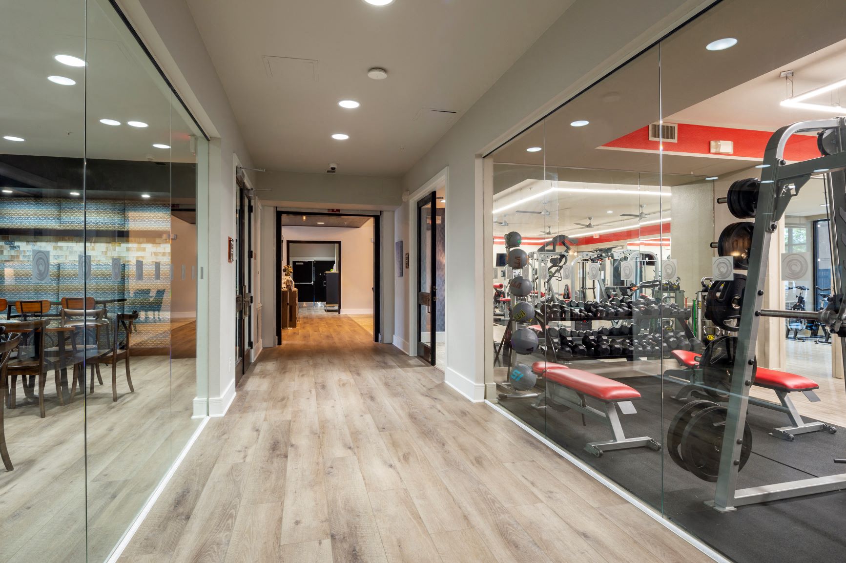 a fitness center with a gym and glass doors