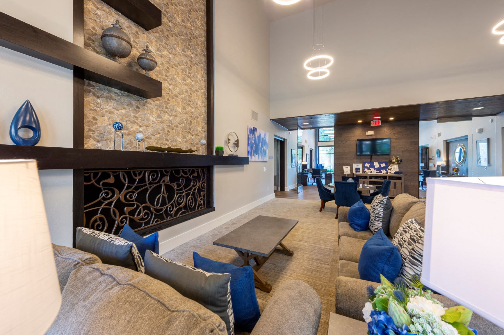 a living room with couches and chairs and a fireplace