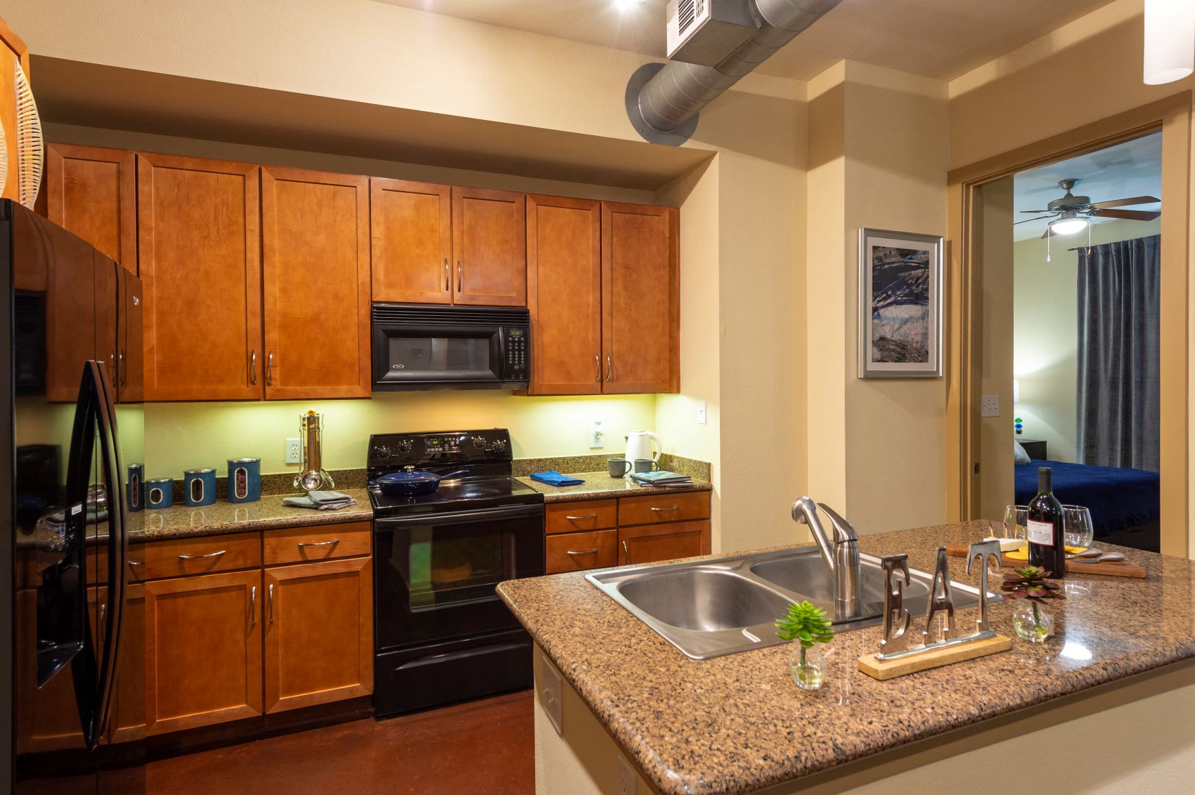 a kitchen with a granite counter top and a sink