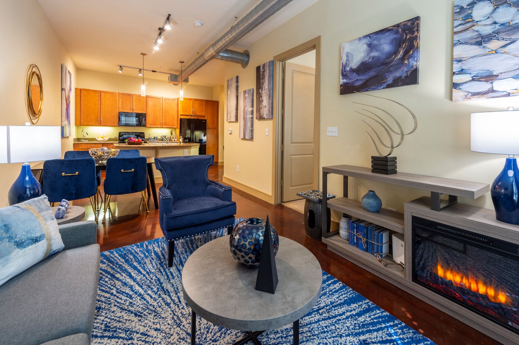 a living room with a fireplace and a couch and chairs
