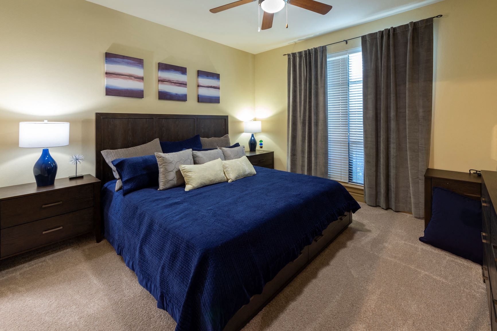 a bedroom with a bed and a ceiling fan