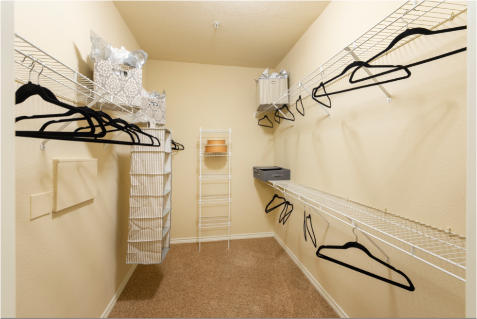 a spacious closet with a lot of clothes and shoes