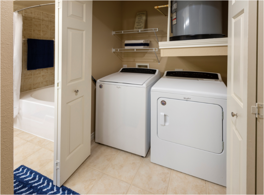 an image of a laundry room with two washer and dryers