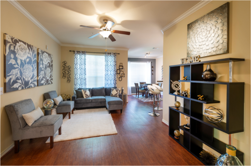 a living room with furniture and a ceiling fan