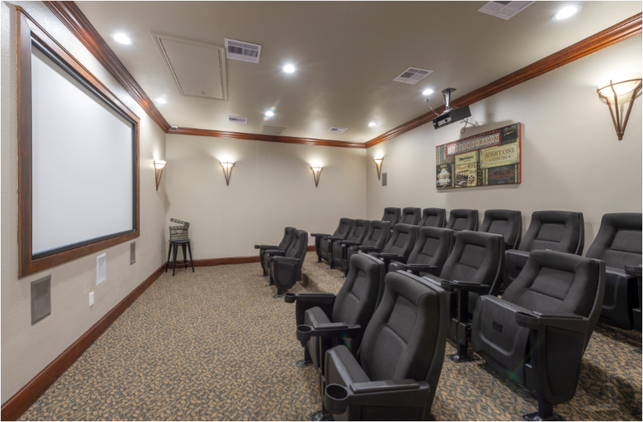 a large room with chairs and a projection screen