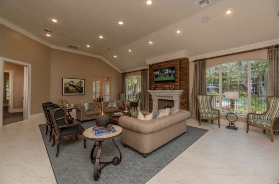 A living room with a fireplace and a television on the wall.
