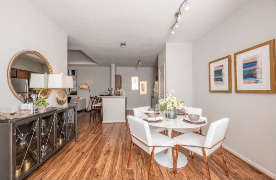 A dining room with a white table and chairs.