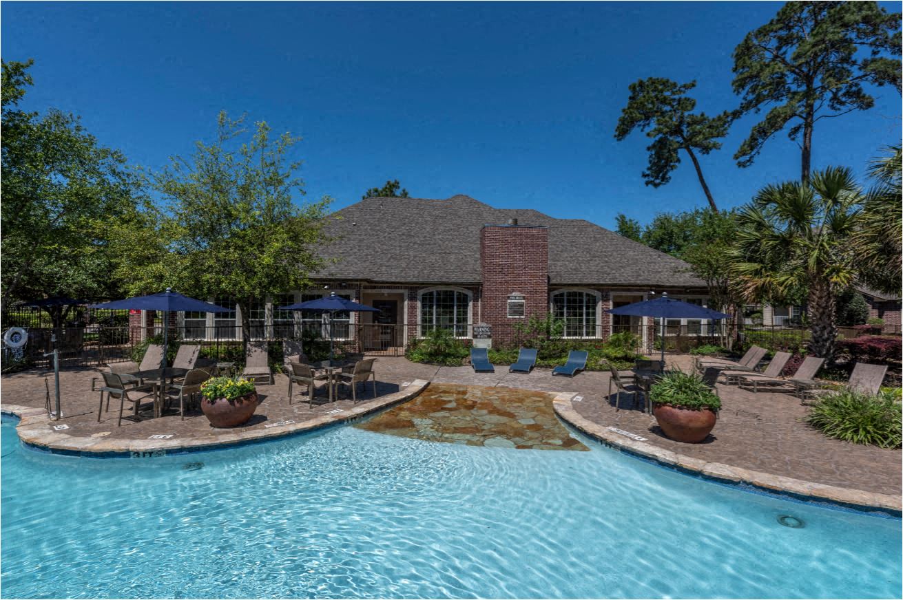 A house with a pool in front of it.