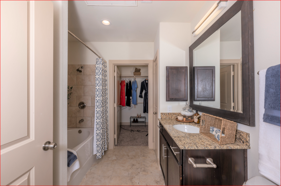 a bathroom with a sink and a shower and a mirror