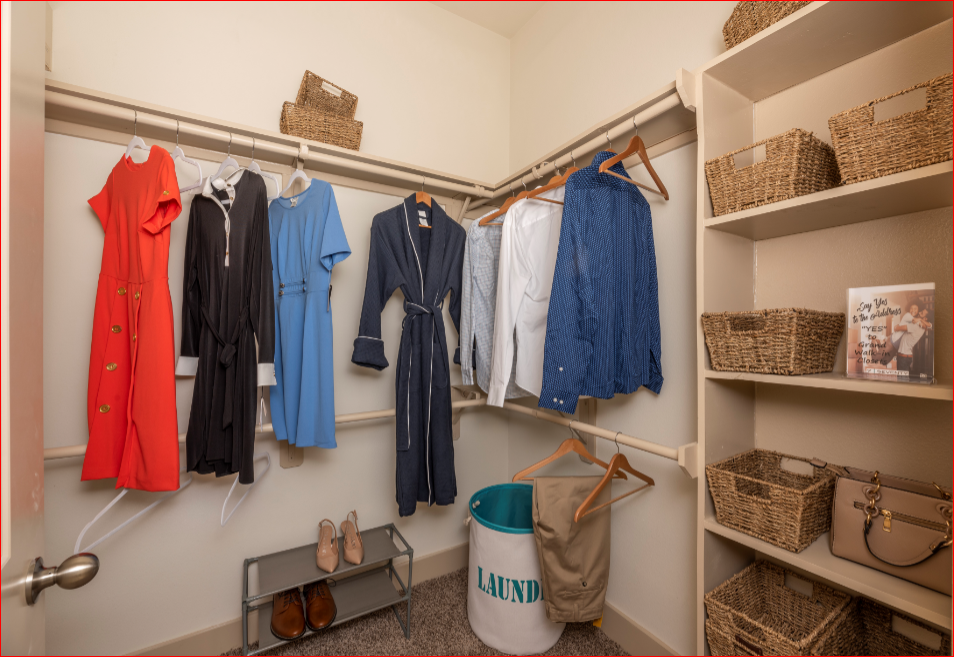 a closet with a lot of clothes hanging on the wall