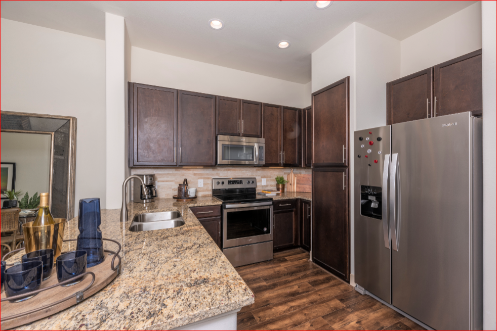 a kitchen with stainless steel appliances and granite counter tops