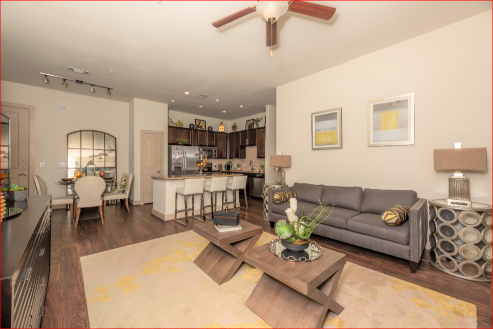 a living room and kitchen with a couch and a table