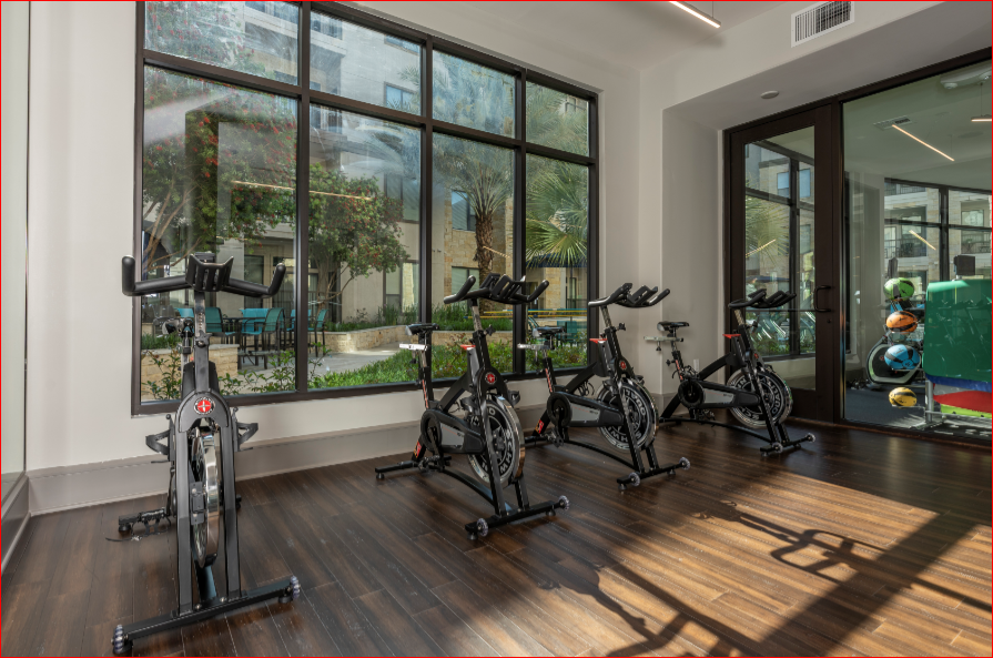 the gym at the district at highland village apartments