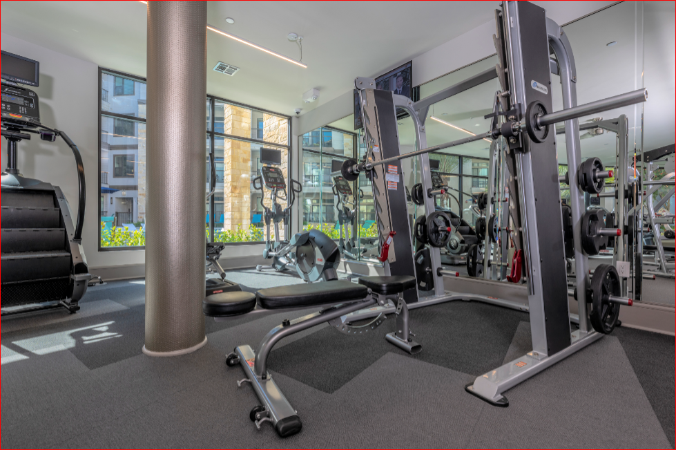 a gym with exercise equipment and windows in a building