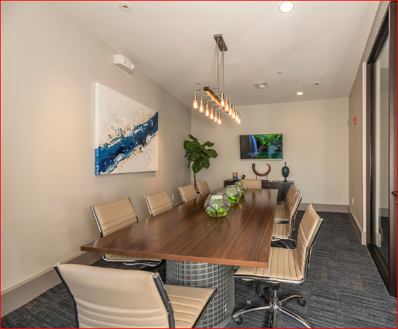 a conference room with a long wooden table and chairs