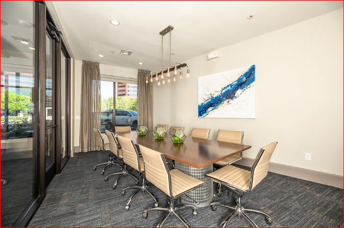 a conference room with a wooden table and chairs