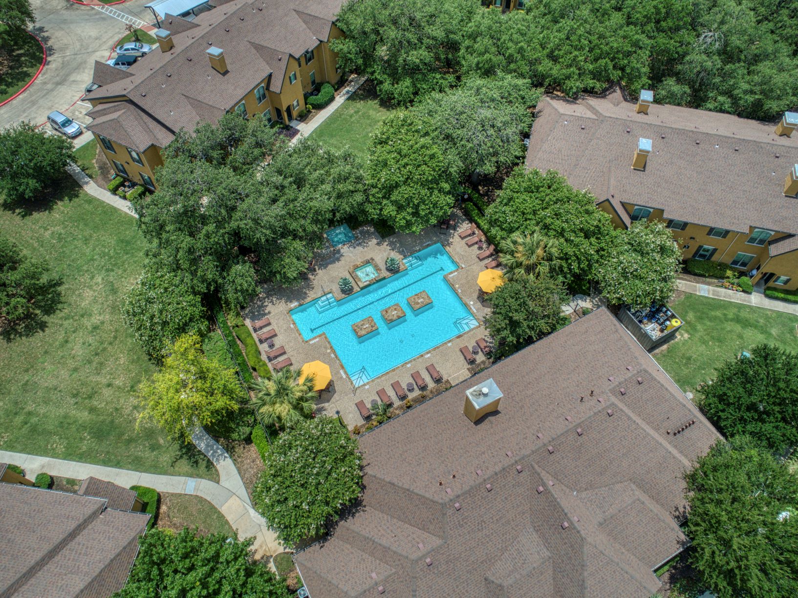 a birdseye view of a neighborhood swimming pool and houses