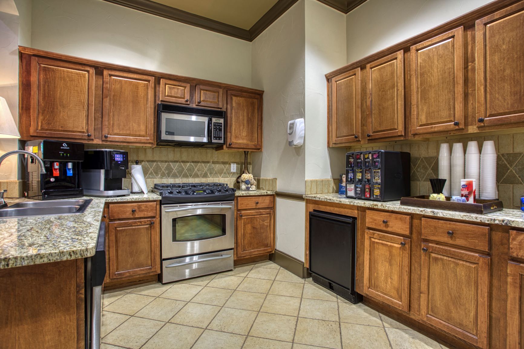 a kitchen with stainless steel appliances and wooden cabinets