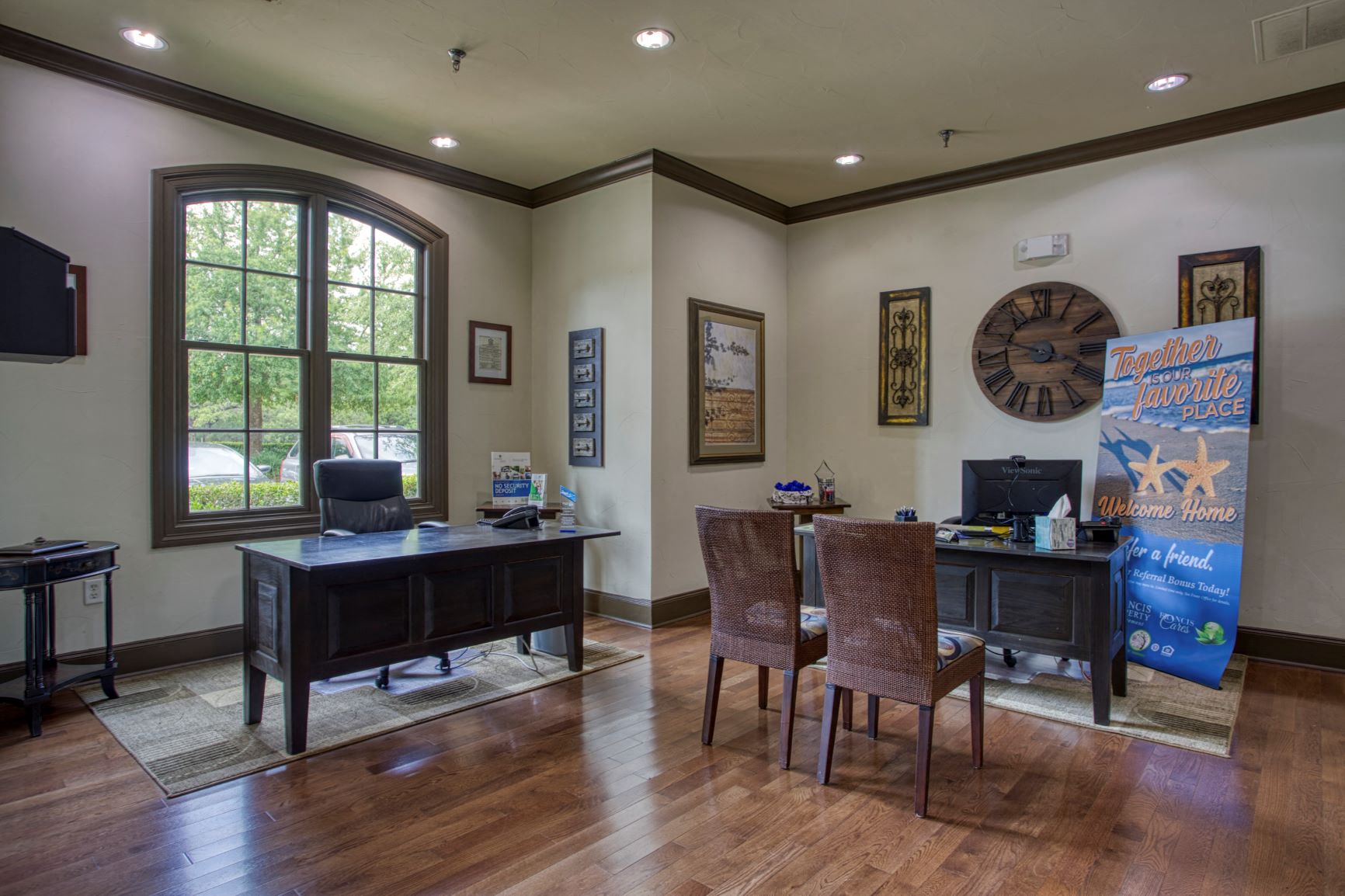 a home office with a desk and a clock on the wall