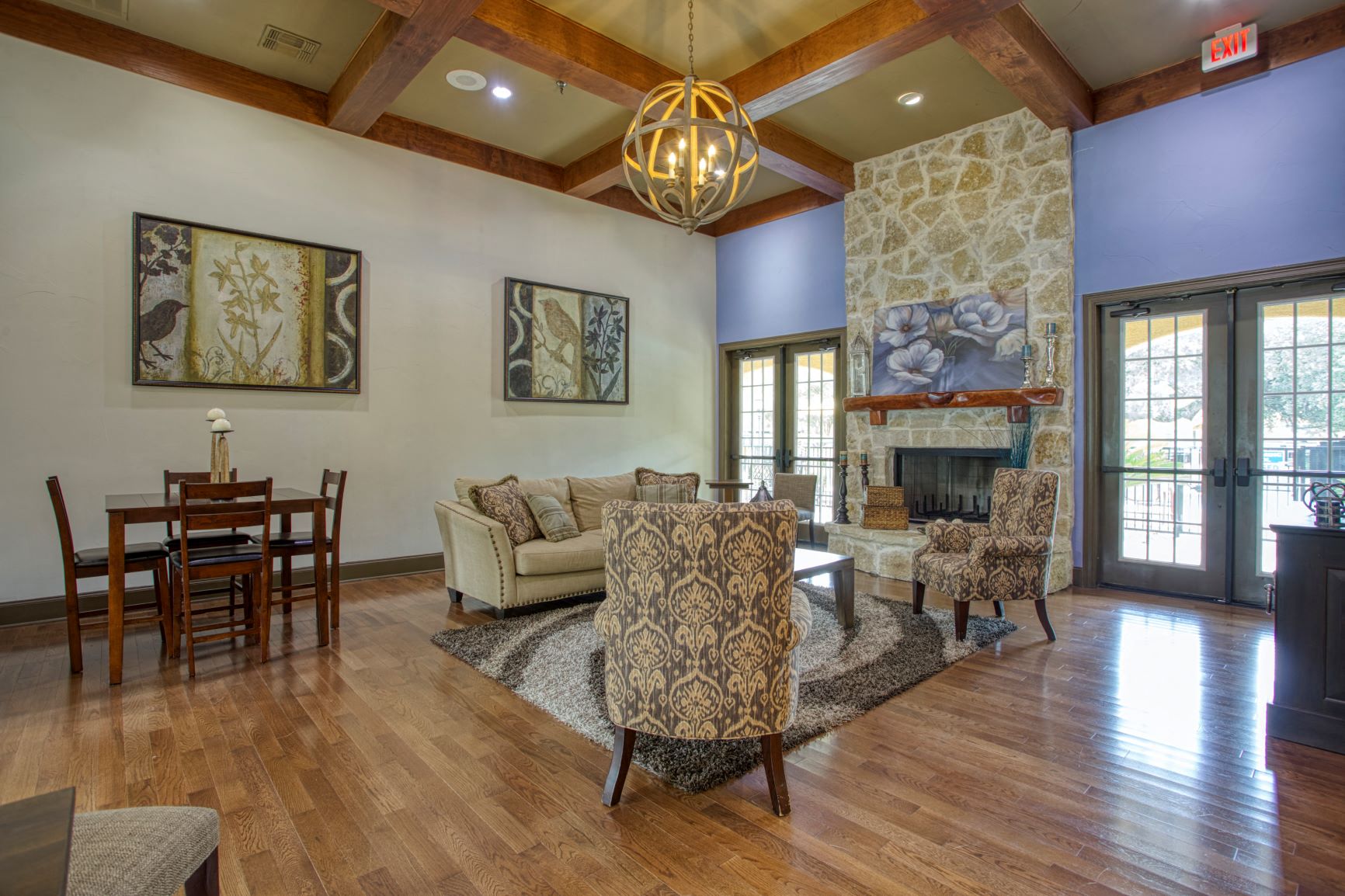 a living room with a fireplace and a dining room