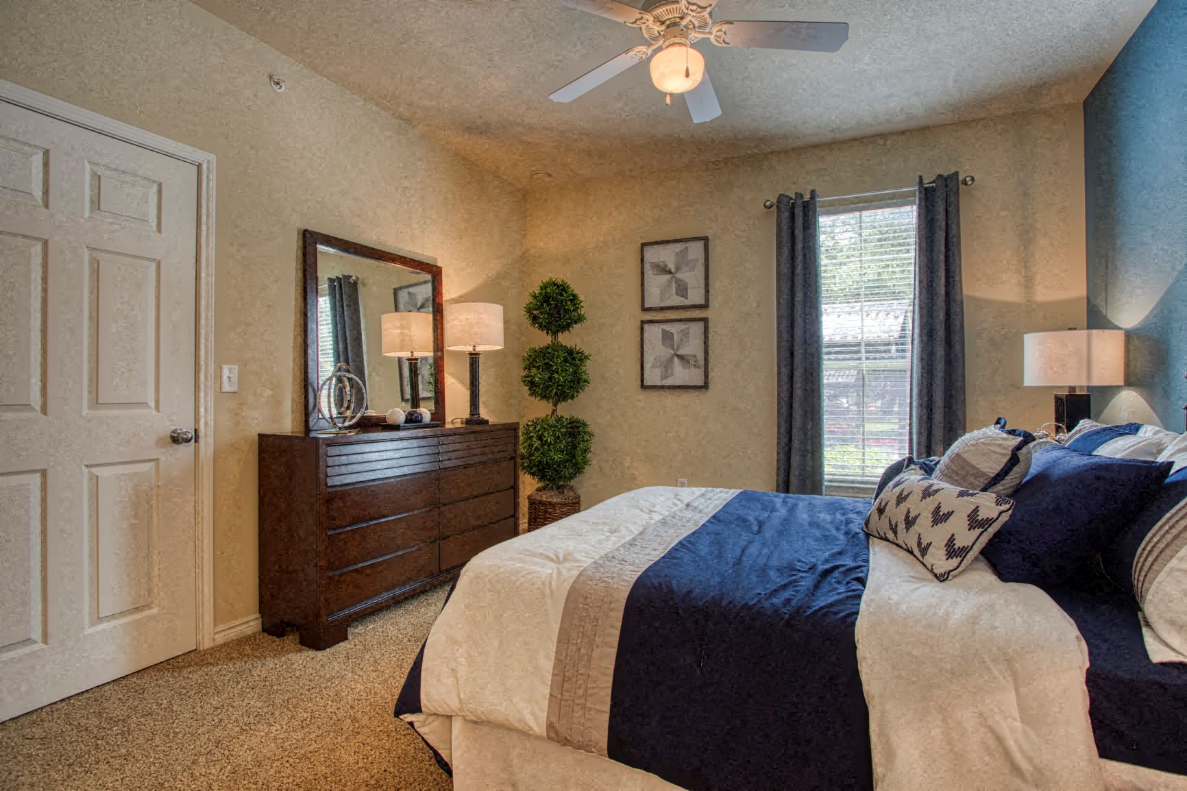 a bedroom with a bed and a ceiling fan