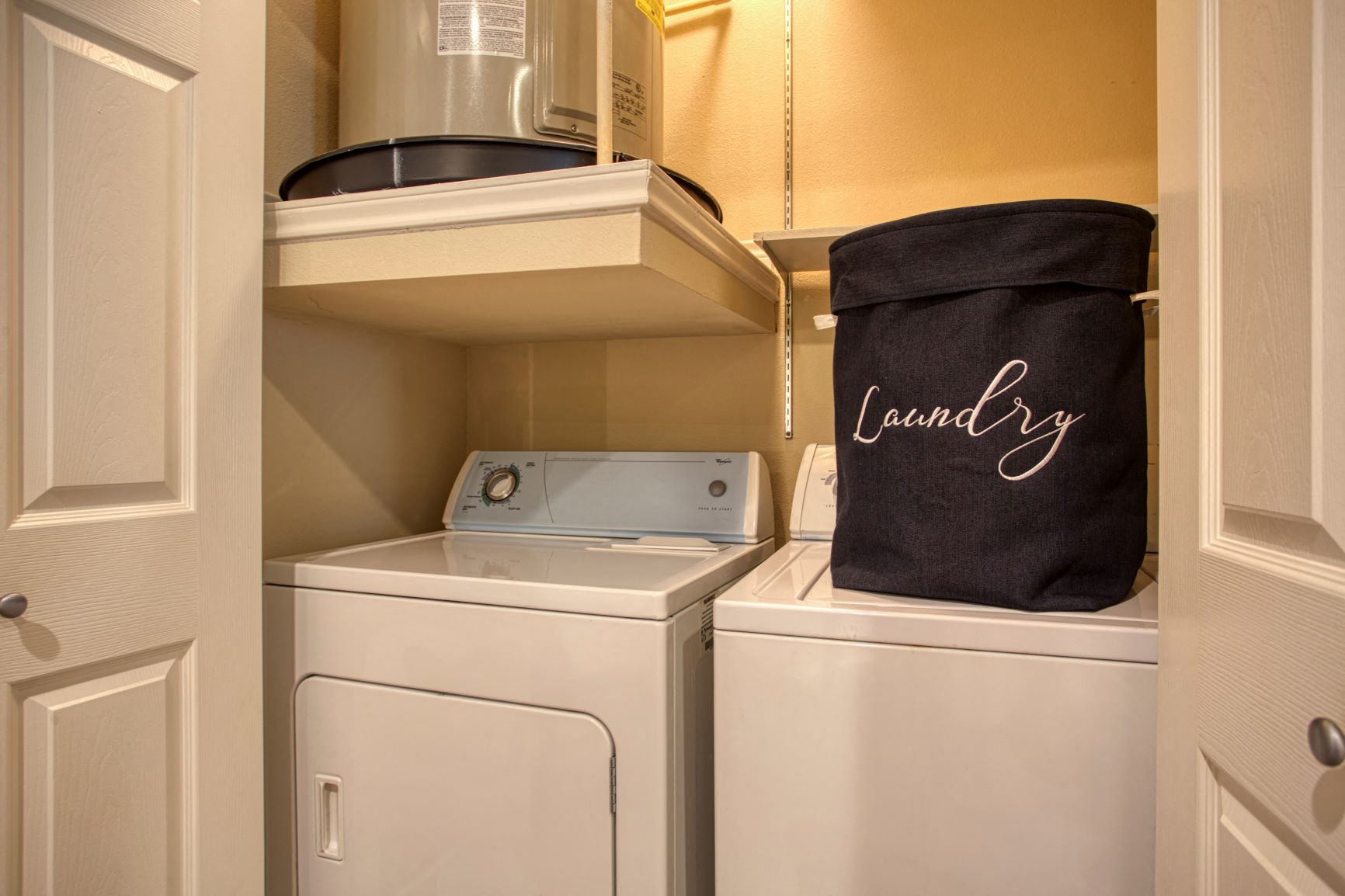 a laundry room with a washer and dryer and a bag
