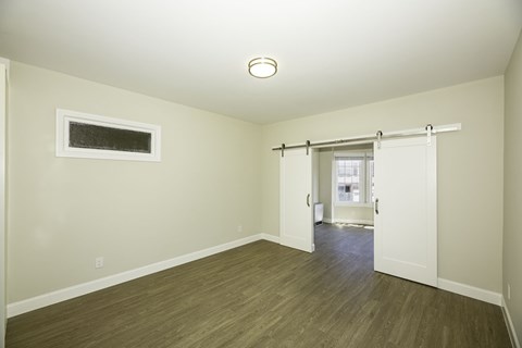 A room with a sliding door leading to another room.