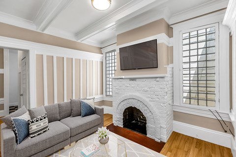 a living room with a fireplace and a couch