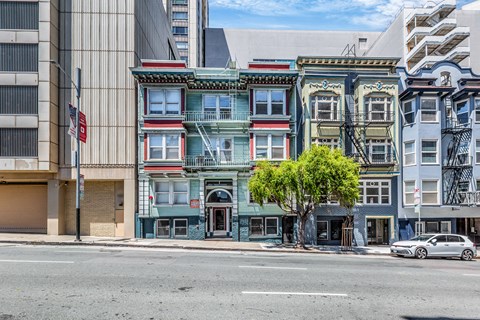 A row of colorful buildings line a street.