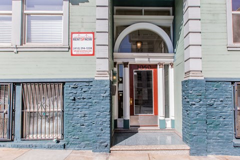 A building with a sign that says "Rent Now" on it.
