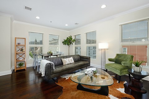 a living room with a leather couch and a coffee table