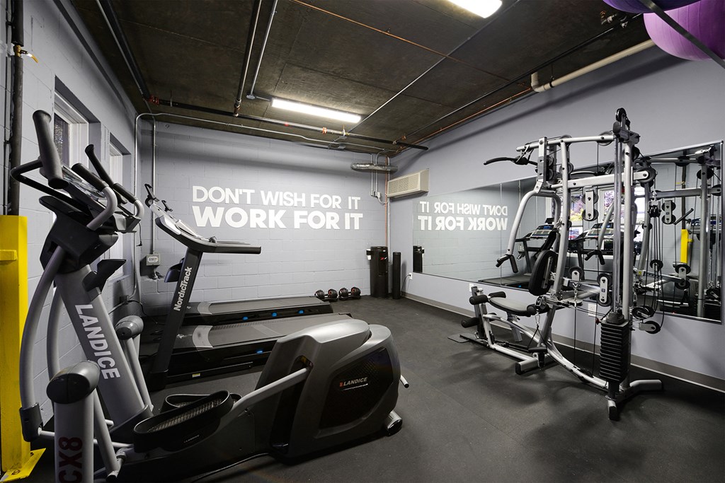 a gym with various exercise equipment and a wall saying dont misuse it work fort