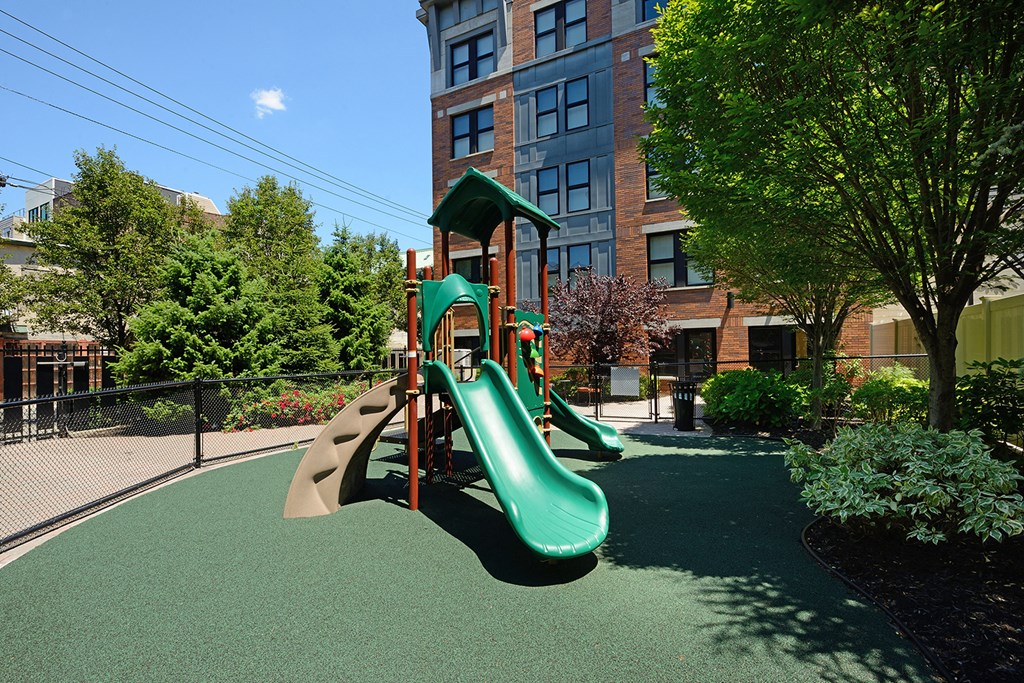 a playground with a slide in front of a building