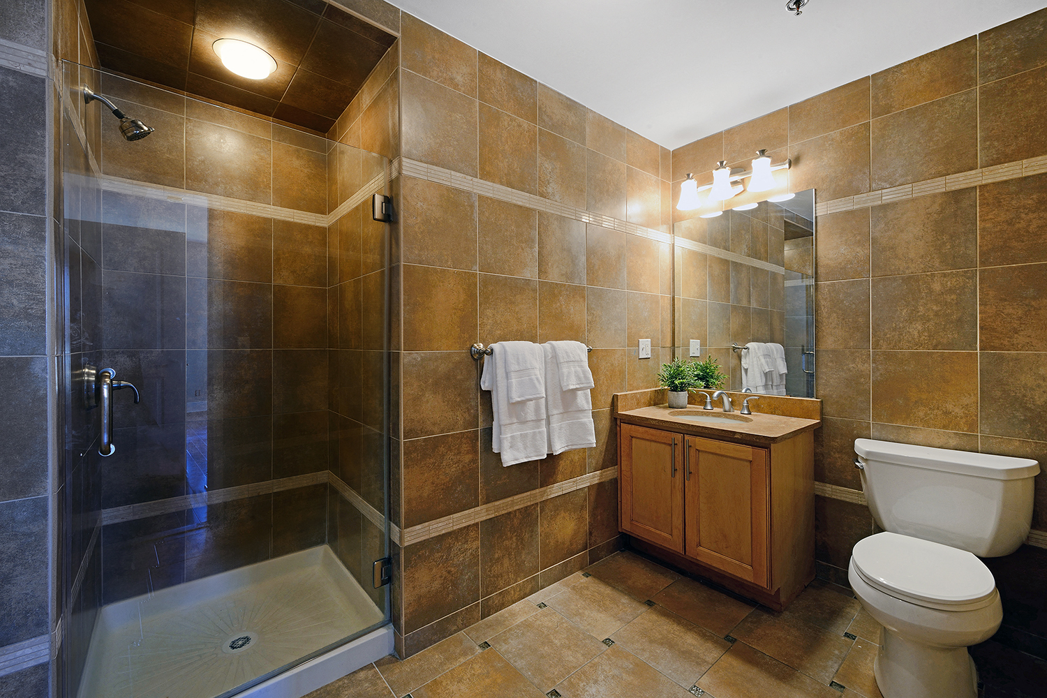 a bathroom with a toilet sink and shower