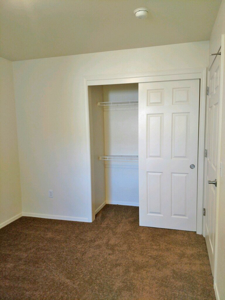 Second bedroom showing single closet with sliding door.  Flooring is carpt.