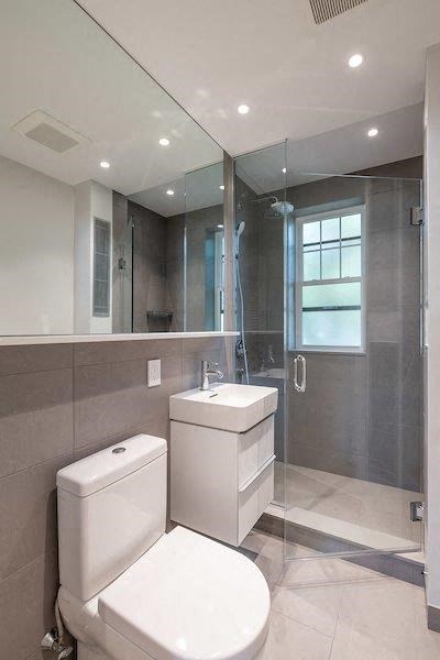 a bathroom with a toilet and a sink and a shower