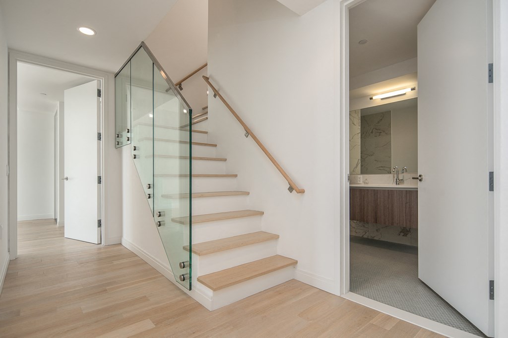 a staircase with glass railings in a modern house