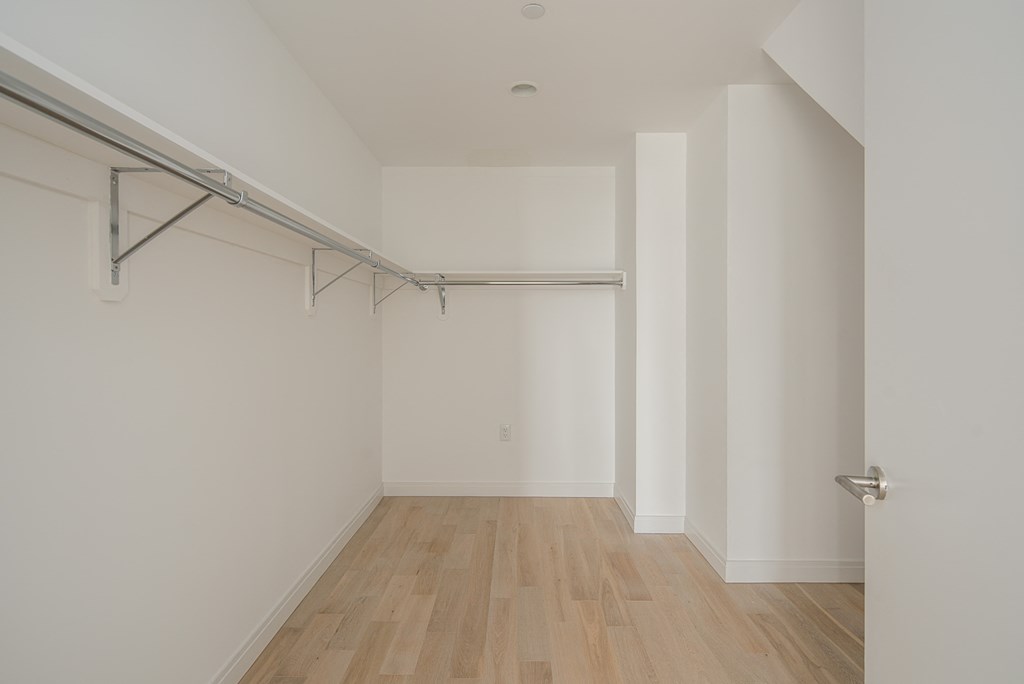 an empty room with white walls and wood floors and a whiteretchedretchedretched ceiling