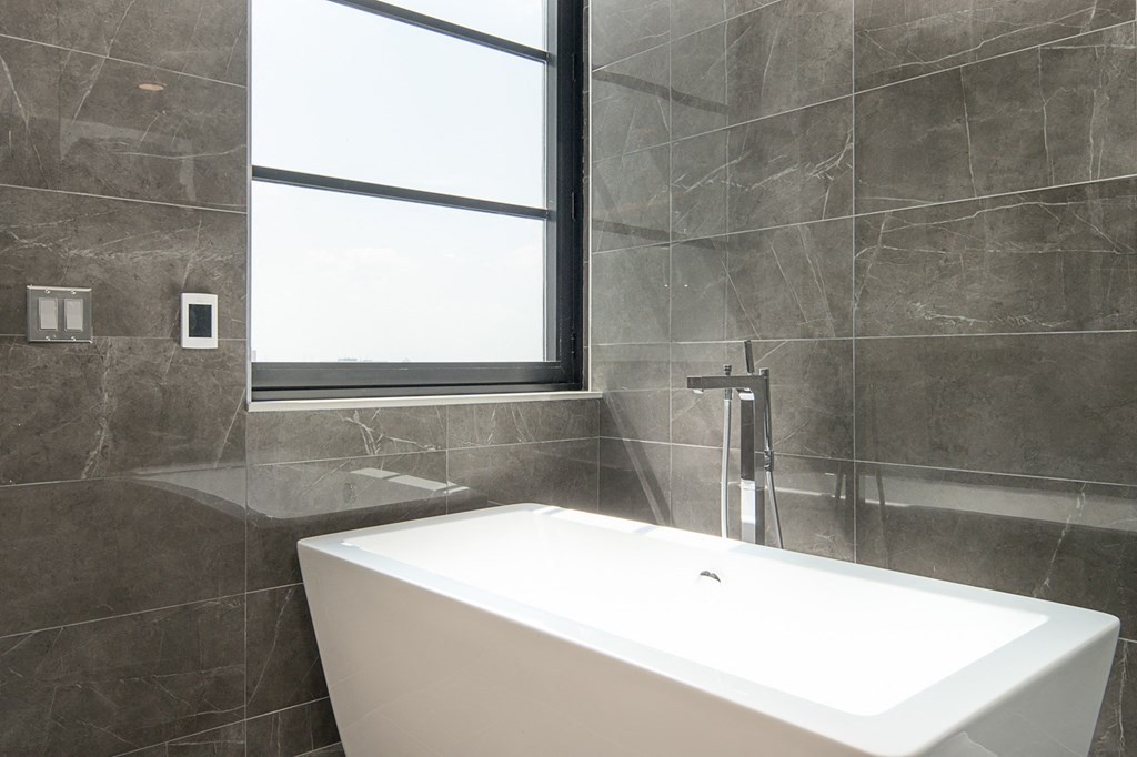 a bathroom with a bath tub and a window