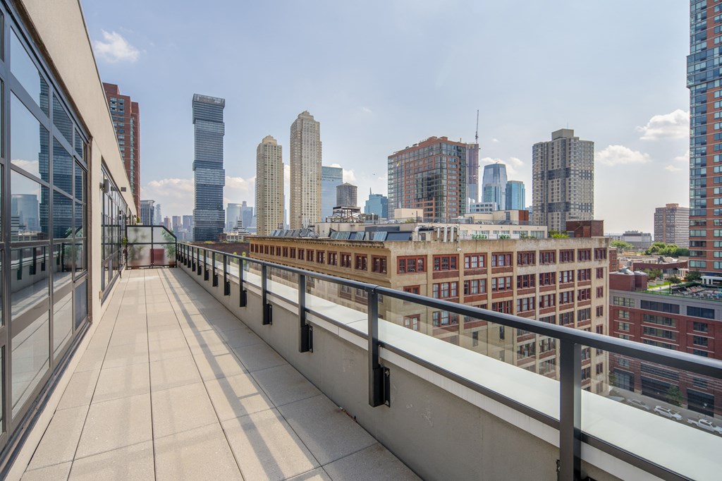 the view of the city from the balcony of a building on a rooftop terrace