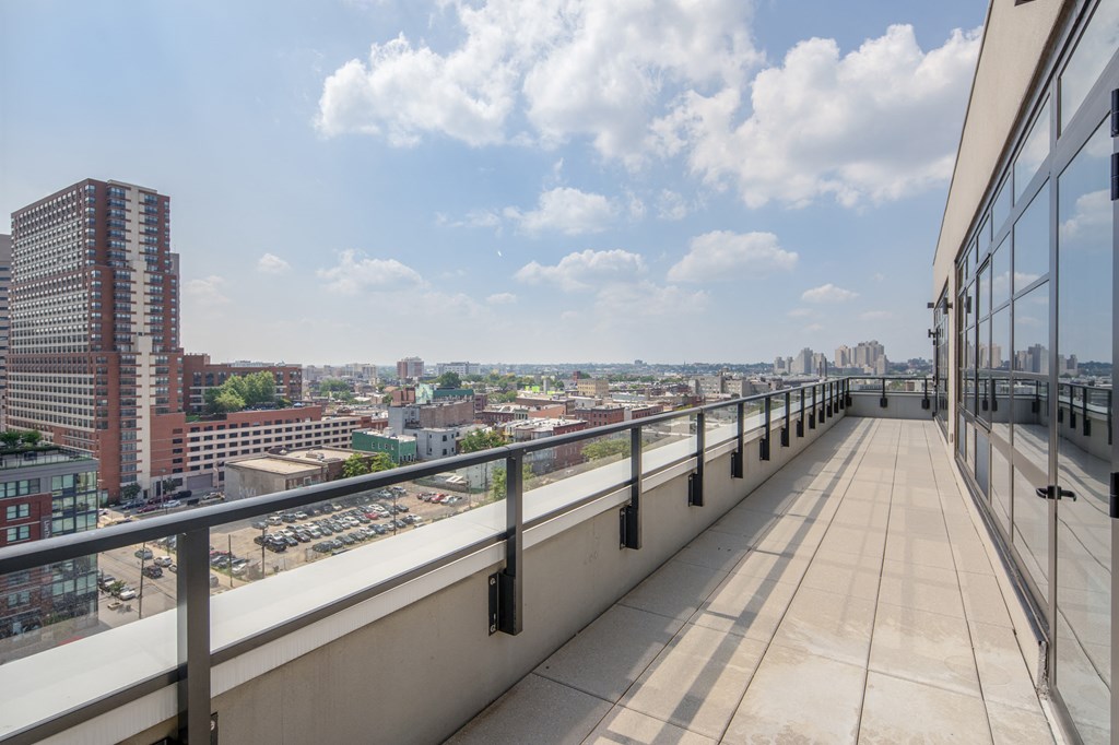 a view of the city from a balcony with a balcony railing