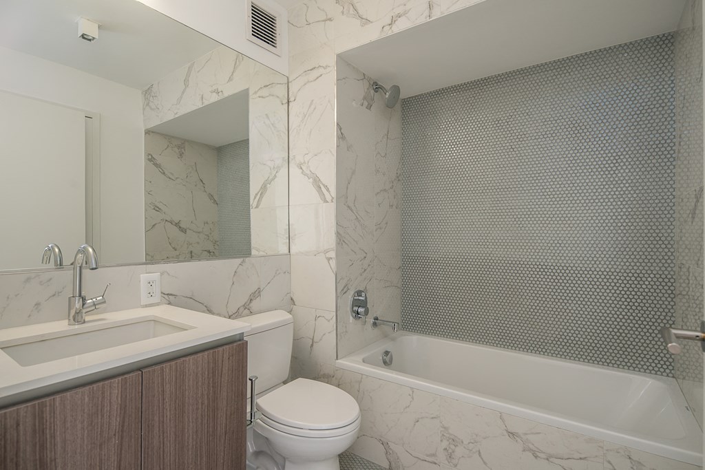 a bathroom with a sink toilet and a tub
