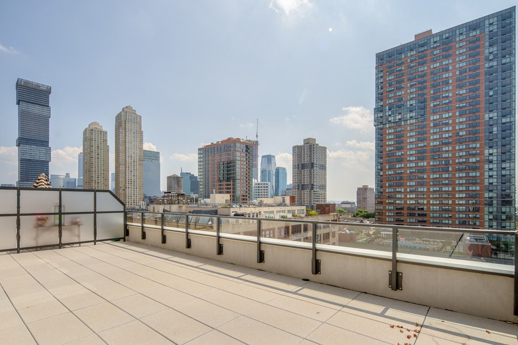 the view of the city from the roof deck of a building with a roof top